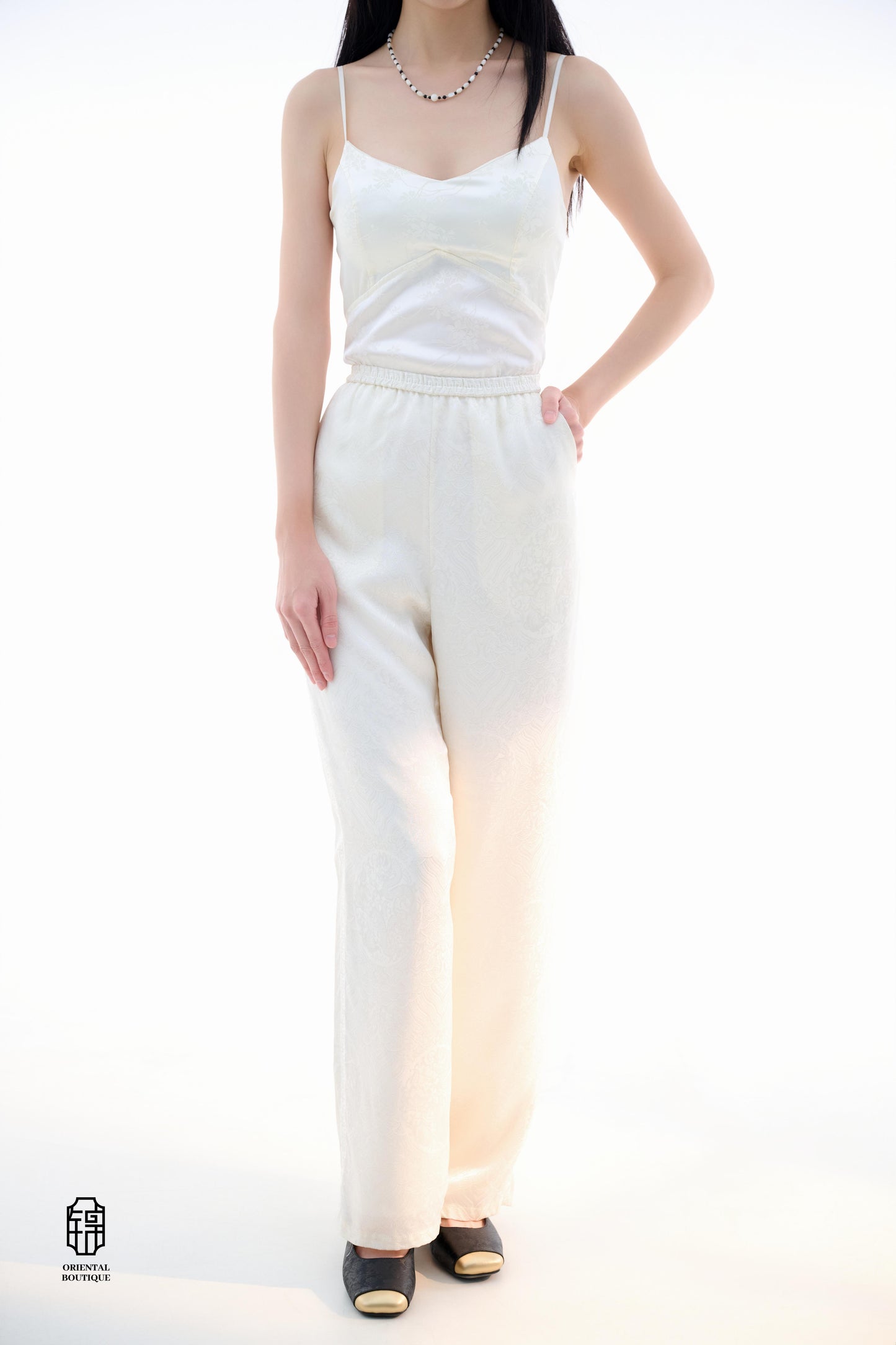 Brocade Trousers,These pants come in two elegant options: ivory and mocha. Made from refined silk fabric with intricate jacquard patterns, they add a touch of luxury to any outfit. The minimalist design and loose fit offer a comfortable wearing experience