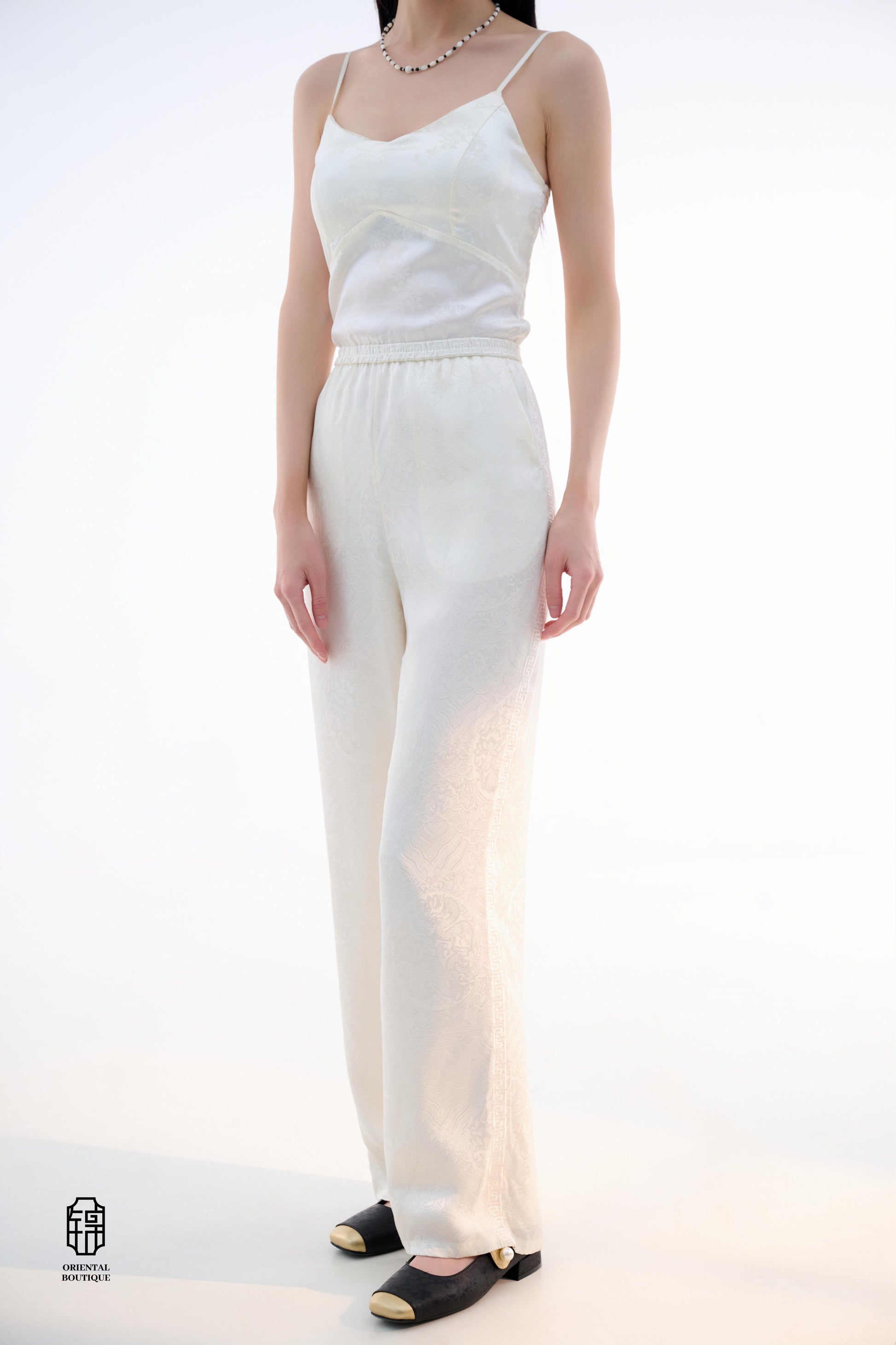 Brocade Trousers,These pants come in two elegant options: ivory and mocha. Made from refined silk fabric with intricate jacquard patterns, they add a touch of luxury to any outfit. The minimalist design and loose fit offer a comfortable wearing experience