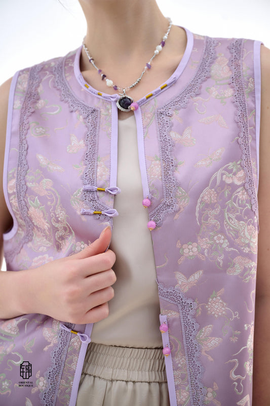 Lilac Blossom Vest,The Lilac Blossom Vest is crafted from light silk fabric in a soft lilac hue, featuring intricate floral and butterfly patterns that exude a fresh and elegant charm. The edges are adorned with delicate lace, adding a touch of femininity