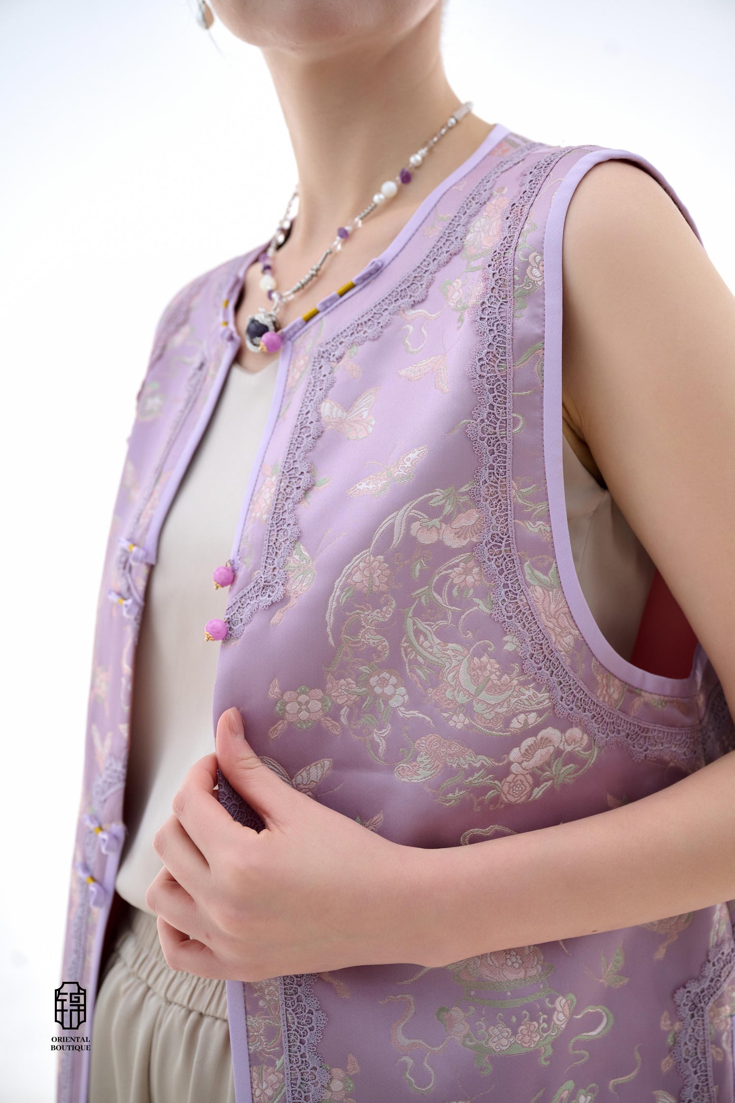 Lilac Blossom Vest,The Lilac Blossom Vest is crafted from light silk fabric in a soft lilac hue, featuring intricate floral and butterfly patterns that exude a fresh and elegant charm. The edges are adorned with delicate lace, adding a touch of femininity