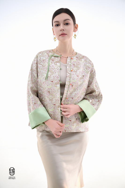 Emerald Blossom Brocade Jacket,The Emerald Blossom Brocade Jacket is crafted from light silk fabric, featuring a refined and elegant design. The jacket is adorned with intricate floral patterns, reminiscent of a sea of blossoms, highlighting the delicate